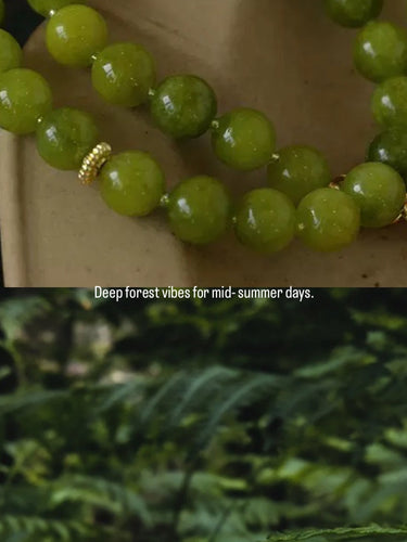 Green beaded bracelet with a gold clasp, shown in two views: one on a neutral background and one overlaid with a nature scene of green ferns. Text at the bottom reads 'Deep forest vibes for mid-summer days.