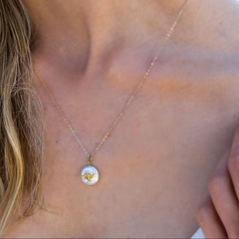 A woman wearing the necklace