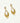 Gold earrings with diamond accents on a white background