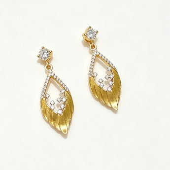 Gold earrings with diamond accents on a white background