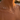 Necklace with pearls worn by a person on a beach at sunset