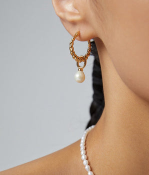 Delicate 18K gold vermeil hoop earrings with 7mm freshwater pearl, shown on a woman’s ear for scale. bridal Earrings.