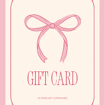 Pink and cream gift card featuring a pink ribbon bow illustration and the text 'GIFT CARD' with 'AD JEWELLERY COPENHAGEN' printed below.
