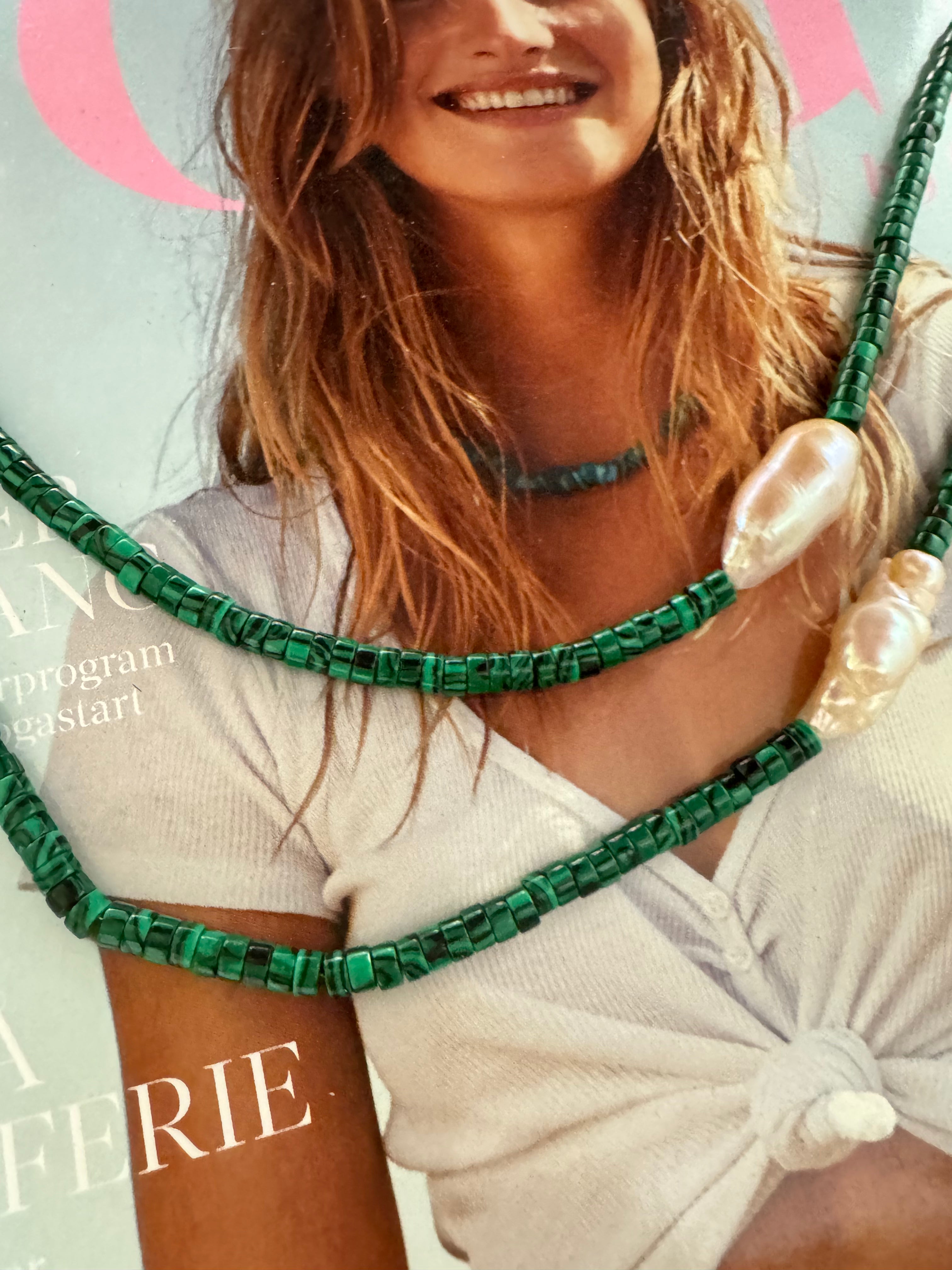 Woman wearing a malachite pearl choker, the green stone evoking Nordic spring forests.