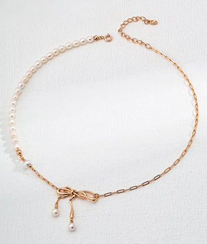 AD Amélie Bow Pearl Necklace featuring freshwater pearls and gold-vermeil paper chain, artfully arranged with the delicate bow accent visible. Adjustable 40cm+5cm chain shown on neutral background for effortless styling