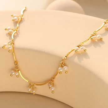 Gold-plated freshwater pearl necklace with organic pearls by a Danish jewelry brand.