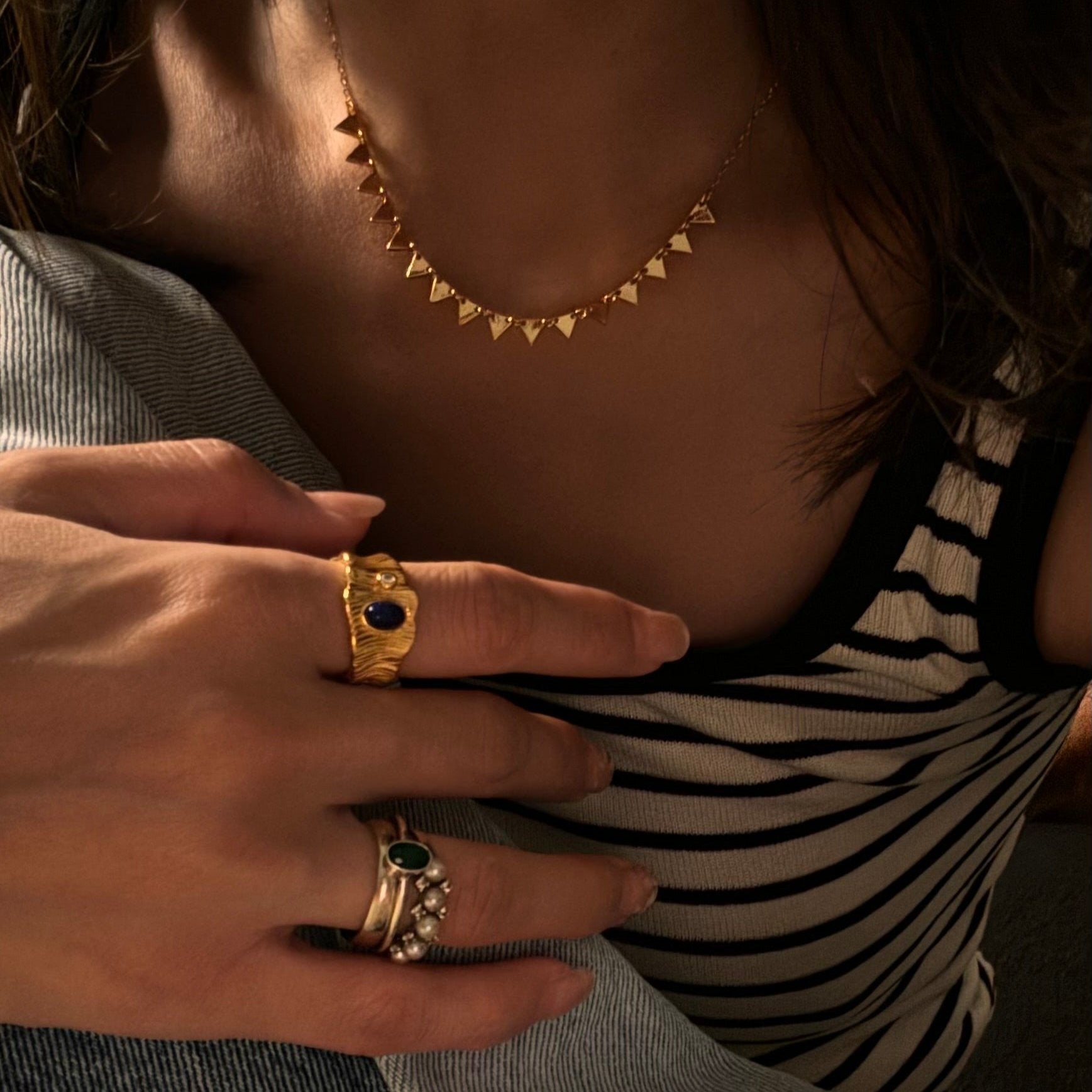 Nordic serrated necklace worn with neutral cashmere, embodying understated elegance for everyday wear