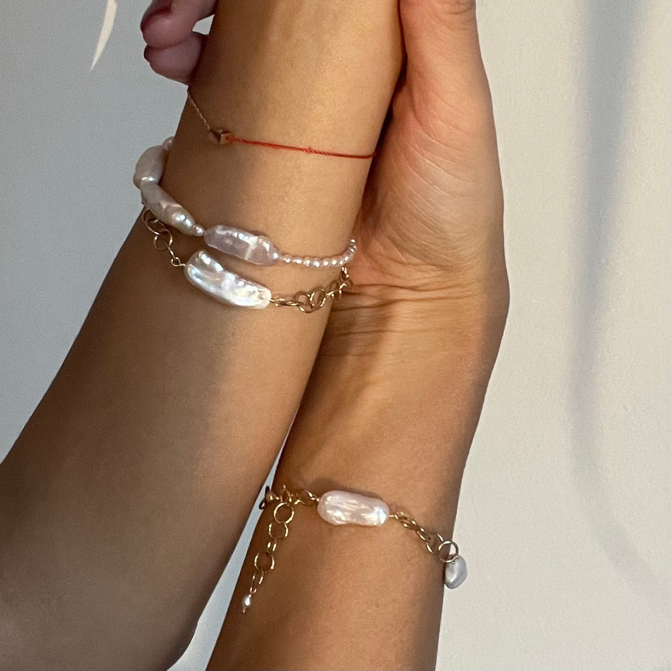 Delicate Danish-made baroque pearl bracelet with 14K gold chain, dancing effortlessly on your wrist - imperfectly perfect luxury