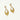 Gold earrings with diamond accents on a white background