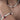 A close-up of a person's neck and arm wearing a matching jewelry set: a pearl necklace and a pearl bracelet, both decorated with small red berry charms and green leaf accents.