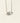 A silver-toned necklace with a marquise-cut clear gemstone pendant, suspended against a plain off-white background.
