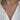A close-up of a person's neck and upper chest wearing a delicate gold chain necklace and a white blouse.