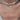 A close-up of a person's neck and chest wearing a layered necklace. The top layer features irregular white baroque pearls on a silver chain, and the bottom layer is a delicate silver chain with a small white textured pendant.