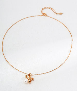 Handcrafted bow pendant with iridescent freshwater pearl on gold vermeil chain