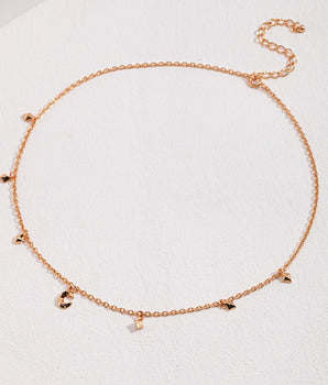 Close-up of moon and star charms on sterling silver necklace, 18k gold plated, celestial charm necklace detail
