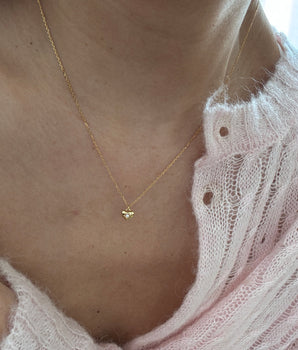 girl wearing gold plated silver mini heart necklace